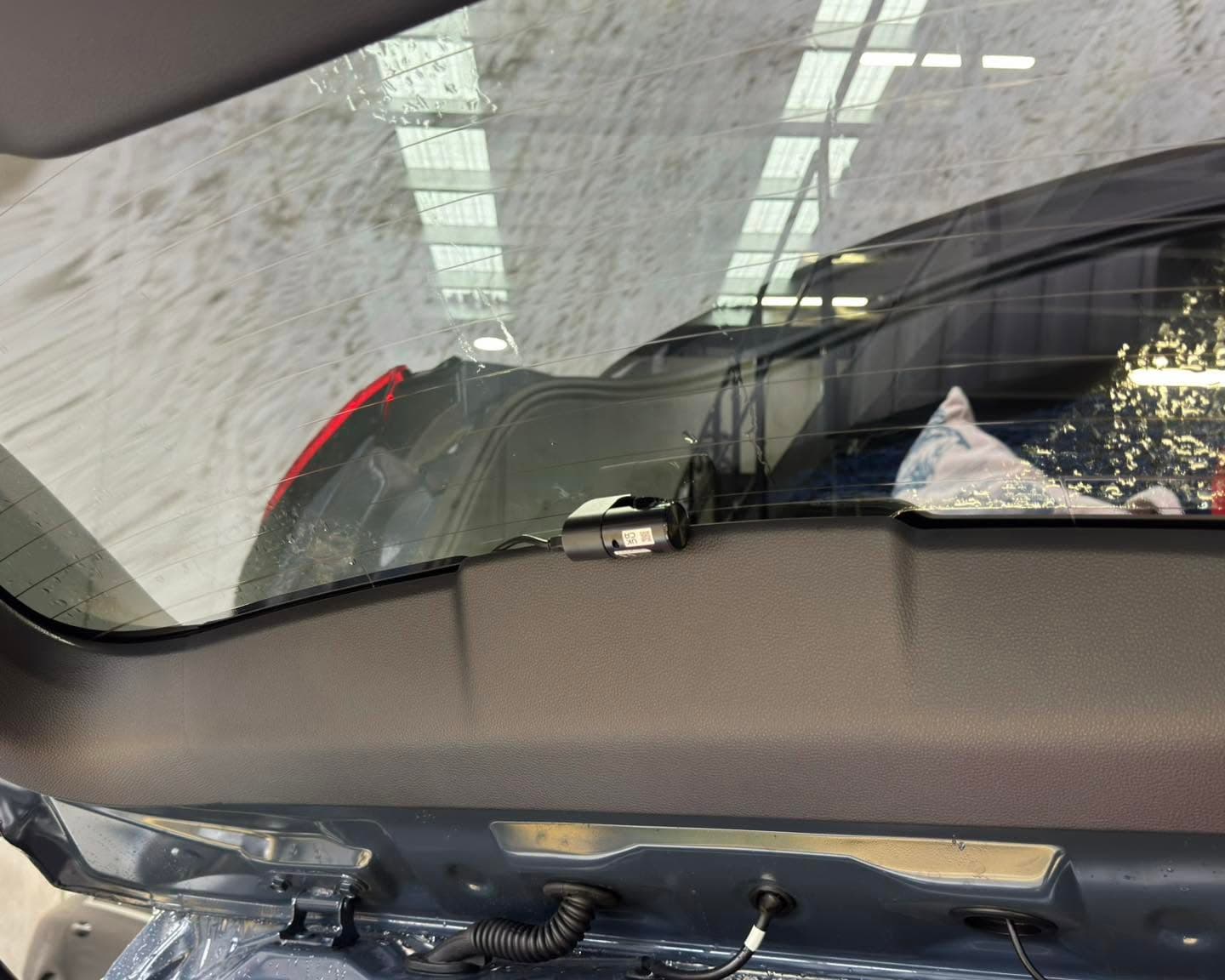 Rear dash camera professionally installed inside a vehicle tailgate window